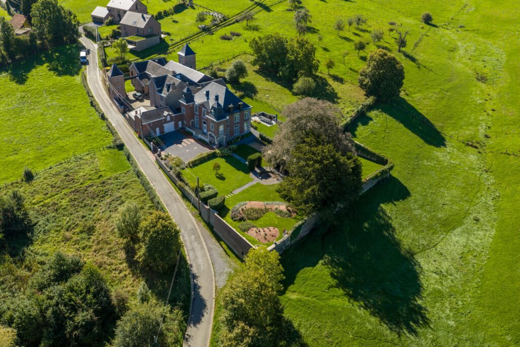 Vue aérienne d'un manoir et de son jardin au cœur de la campagne